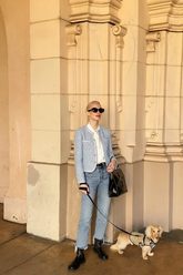 a lady wears a baby blue crop jacket with straight leg jeans